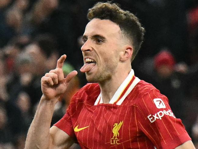 Liverpool's Portuguese striker #20 Diogo Jota celebrates after scoring their second goal during the English Premier League football match between Liverpool and Fulham at Anfield in Liverpool, north west England on December 14, 2024. (Photo by Oli SCARFF / AFP) / RESTRICTED TO EDITORIAL USE. No use with unauthorized audio, video, data, fixture lists, club/league logos or 'live' services. Online in-match use limited to 120 images. An additional 40 images may be used in extra time. No video emulation. Social media in-match use limited to 120 images. An additional 40 images may be used in extra time. No use in betting publications, games or single club/league/player publications. /