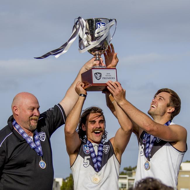 Southport Sharks coach Stephen Daniel celebrates with captains, Andrew Boston and Seb Tape after winning the cup last season. Picture: Jerad Williams