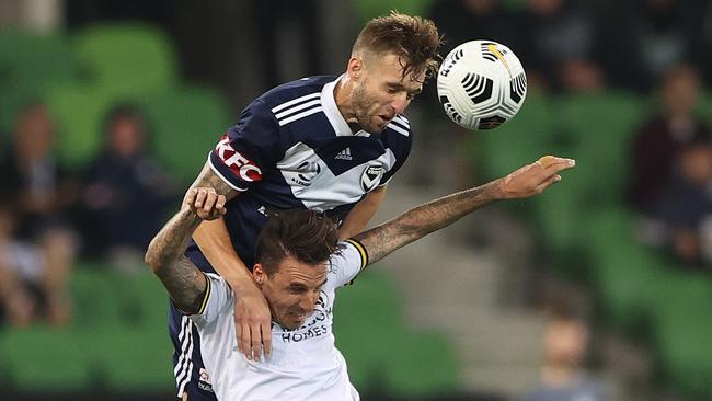 Nick Ansell of the Victory challenges Matt Derbyshire of Macarthur FC during an A-League match.