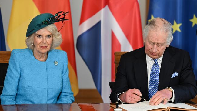 Camilla, Queen Consort and King Charles III sign the Golden Book as they visit Schloss Bellevue in Berlin, Germany. Picture: Getty Images.