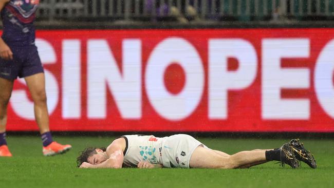 Darcy Byrne-Jones of the Power lays on the turf after the hit. (Photo by Janelle St Pierre/AFL Photos via Getty Images)