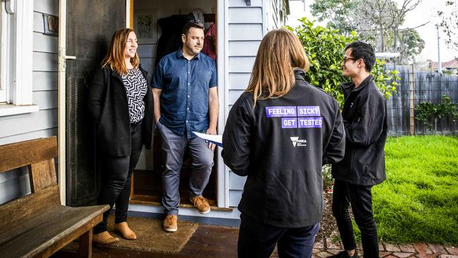 COVID officers Joey Nguyen and Sonia O’Neill go door-to-door in hotspot suburbs to check in with residents, such as Sasha and Stephen Torsi. Picture: Nicole Cleary