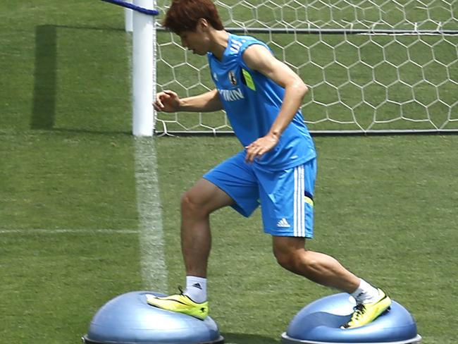 Japan's soccer team players Hiroshi Kiyotake, left, Yusa Osako, center, and Shinji Okazaki work out during a training in Tokyo, Monday, May 19, 2014. Japan soccer team is drawn in a Group C with Ivory Coast, Greece and Colombia at the World Cup in Brazil. (AP Photo/Shuji Kajiyama)