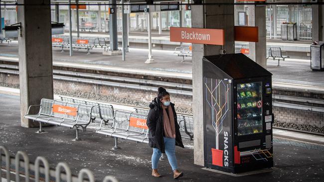 A lone woman wearing a mask at Blacktown Station, western Sydney. Picture: James Gourley