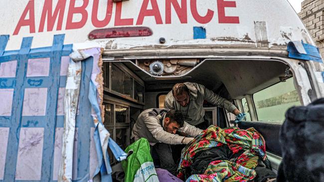 Palestinian paramedics recover the remains of bodies rescued from a wrecked car following reported Israeli bombardment in Rafah in the southern Gaza Strip on February 6, 2024. Picture: Said Khatib/AFP