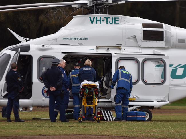 NSW Ambulance paramedics stabilise the man before he was flown by the Ambulance helicopter to Royal North Shore Hospital. Picture: Sebastien Dekker