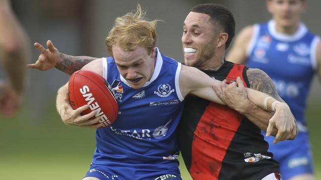 Adelaide Footy League division one game between St Peter's Old Collegians and Tea Tree Gully at St Peters. St Peters Nick McGill tries to break free from TT Gully's James Harley. 11 May 2019. (AAP Image/Dean Martin)