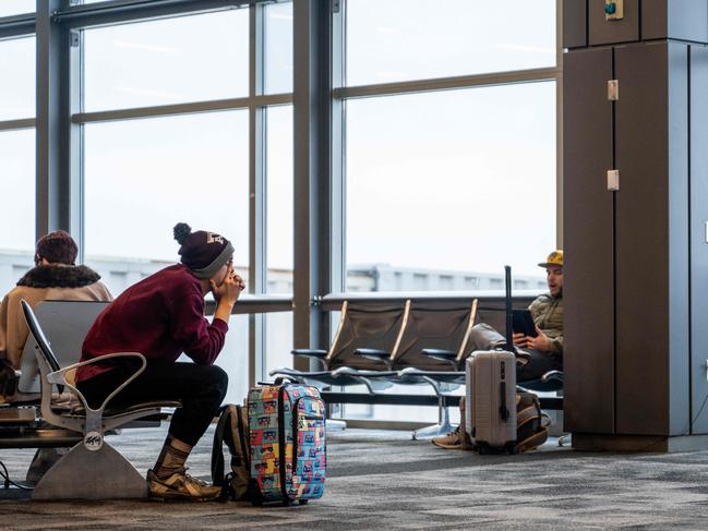 AUSTIN, TEXAS - JANUARY 15: A traveler sits waiting for their flight to depart at the Austin Bergstrom International Airport on January 15, 2024 in Austin, Texas. Airlines across the country continue experiencing mass cancellations and delays as intense storms continue sweeping across the eastern half of the United States.   Brandon Bell/Getty Images/AFP (Photo by Brandon Bell / GETTY IMAGES NORTH AMERICA / Getty Images via AFP)