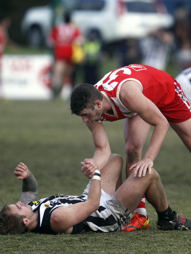 2014: James Hallahan consoles Crib Point’s Brad Arnold. Picture: Richard Serong