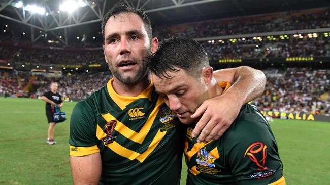 An emotional Cooper Cronk (right) with Australian captain Cameron Smith following Australia’s Rugby League World Cup final win over England on Saturday night.