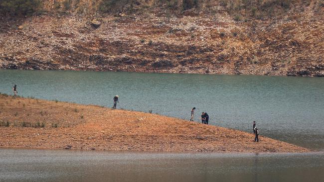 Police sniffer dogs were brought in to help with the search of reservior banks. Picture: AFP