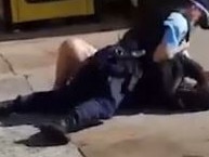 Still grabs from  footage showing NSW police officers punching and kneeing two men accused of not wearing masks at a Guildford service station.  SUPPLIED