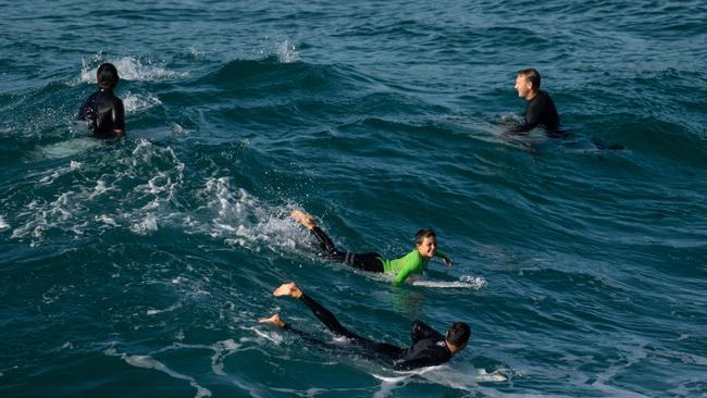 Surfers in the water at MacKenzies Bay on Saturday. Picture: AAP