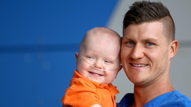 Nurse Dakota Parker is reunited with his former charge, Ethan Moodie, who is now 15 months’ old. Picture: Bruce Long