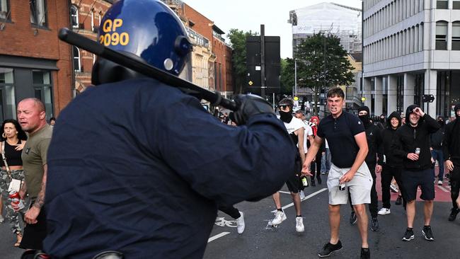 Riot police face protesters in Bristol on Saturday during an 'Enough is Enough' demonstration. Picture: AFP