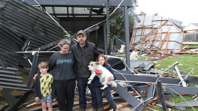 Simon Aitken and his family survey the damage in Waurn Ponds. Picture: David Crosling