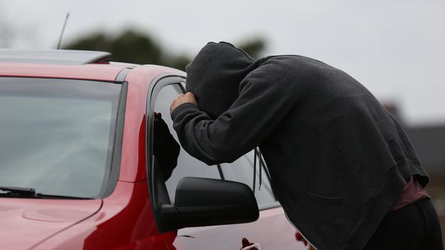 An elderly man has been robbed overnight while sitting in his car just up the road from a police station