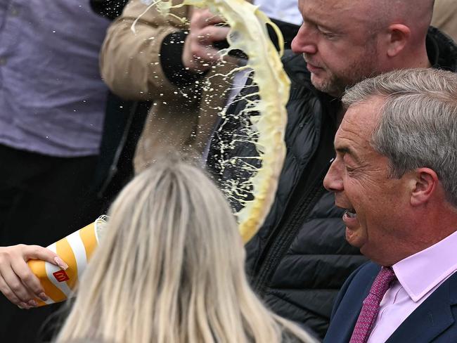 Nigel Farage reacts as he is about to be hit in the face by the contents of a drinks cup, during his general election campaign launch in Clacton-on-Sea, eastern England. Picture: AFP