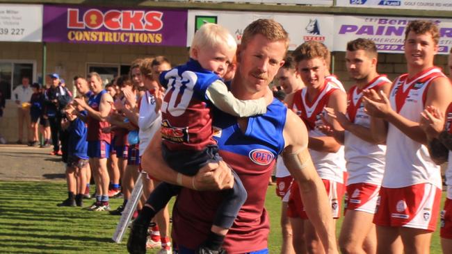 Horsham Demons and Ararat players form a guard of honour as Brad Hartigan runs onto the ground for his 300th match in the Wimmera league. Picture: Eliza McAnulty