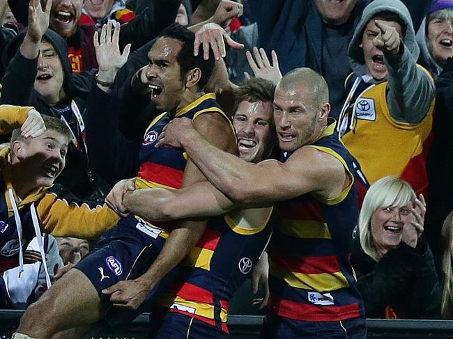 23/06/2014 CHP: 23/06/2014 CHP: AFL - Adelaide Crows v North Melbourne at Adelaide Oval. Eddie Betts celebrates his goal with Matthew Wright and Scott Thompson. Photo Sarah Reed.