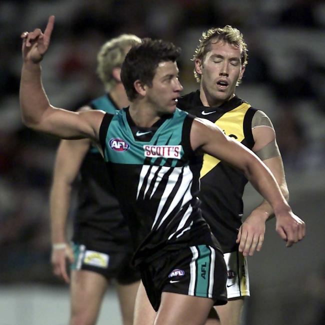 Josh Carr kicks a goal against the Tigers during his playing career.