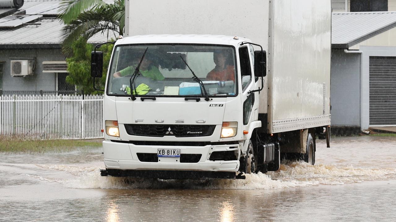 A truck drives through flood water on Campbell Street in Gordonvale after heavy rain caused flooding to the area south of Cairns. Picture: Brendan Radke