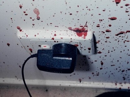 Blood splattered on a wall and power socket inside Min and Lily’s bedroom.