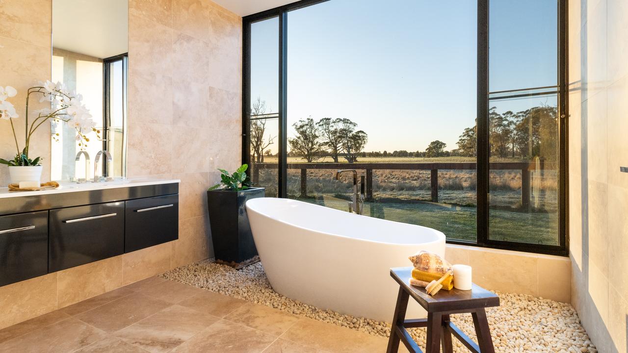 There are two bathrooms, including one with this stunning bath overlooking the fields.