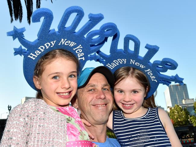 Michael Stoltz with his daughters, Sarah, 7, and Minnie, 5, wait for the fireworks. Picture: Jay Town