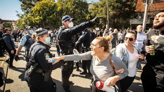 A woman screams at police officers in Victoria Park in Chippendale. Picture: Julian Andrews