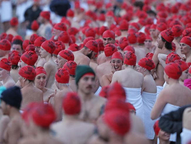 DARK MOFO 2019: Participants of the nude solstice swim brave the cold water at dawn at Long Beach, Sandy Bay. Picture: LUKE BOWDEN