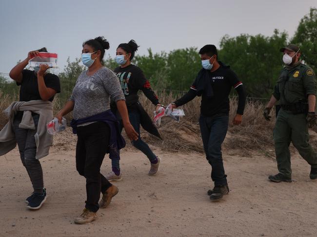 US Border Patrol agents process a group of people they caught crossing the border from Mexico in Penitas, Texas. Picture: AFP