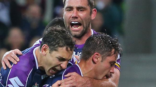 Cameron Smith celebrates with Billy Slater and Cooper Cronk.