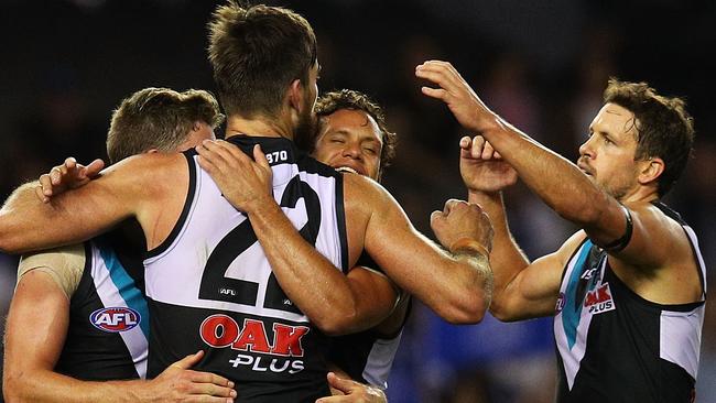 Boak celebrates a goal in the win over the Kangaroos with his teammates.