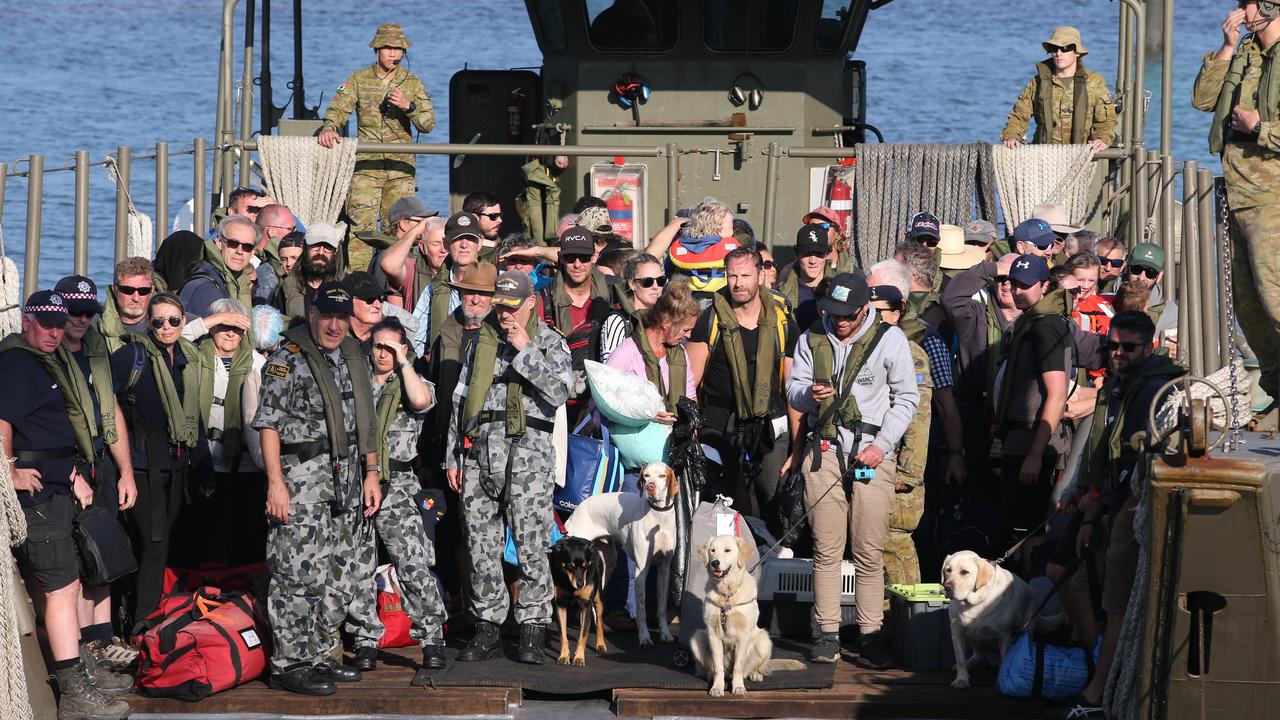 Evacuees from Mallacoota disembark at HMAS Creburus after travelling on HMAS Choules from Mallacoota. Picture: The Australian