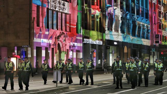 A large group of police patrol White Night on Flinders Street. Picture: Hamish Blair