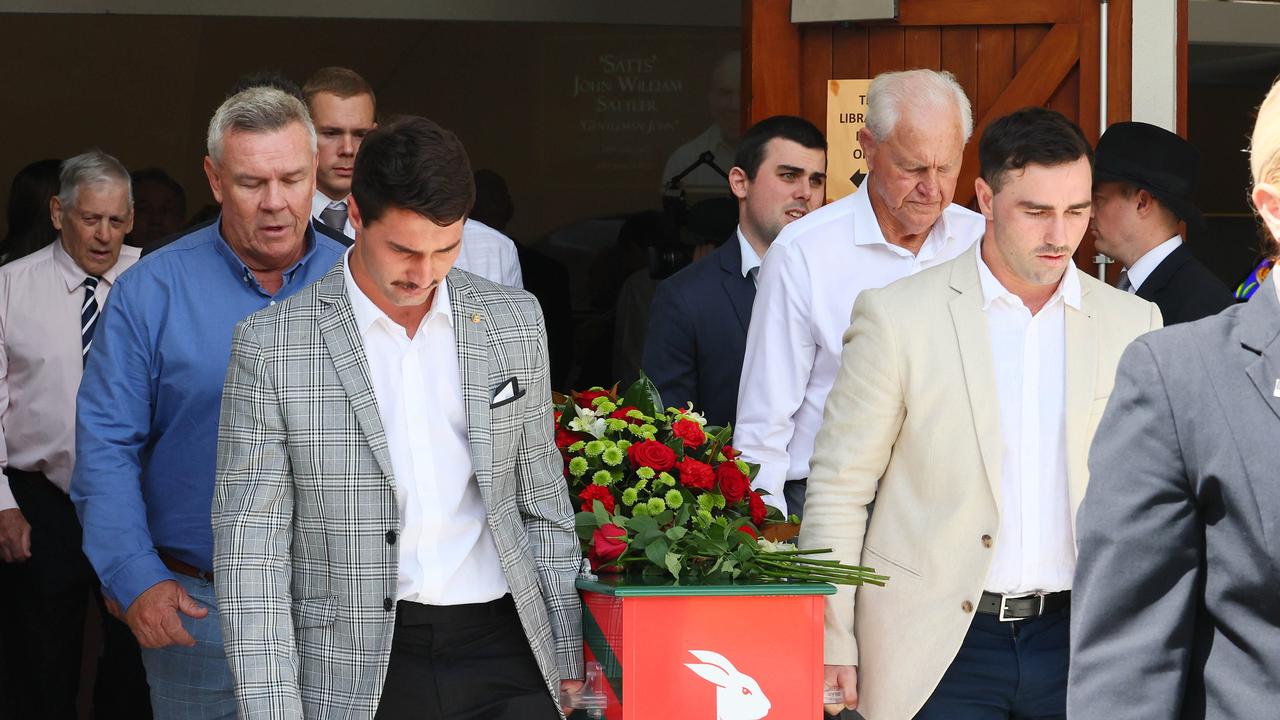 Grandchildren Blake Scott and Jack Sattler, front, Troy McCarthy, and Ron Coote with the casket during the funeral for Souths legend John Sattler on the Gold Coast. Picture: NCA NewsWire/Tertius Pickard