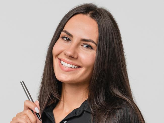 Smiling confident caucasian young businesswoman auditor writing on clipboard, signing contract document isolated in white background; checklist generic