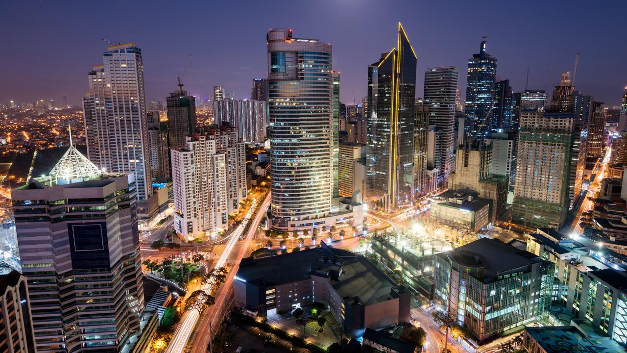 The Manila skyline glows at night.