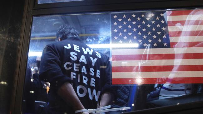 Cuffed protesters arrested during a demonstration calling for a ceasefire amid war between Israel and Hamas, are been transported by NYPD at Grand Central Station. Picture: AFP