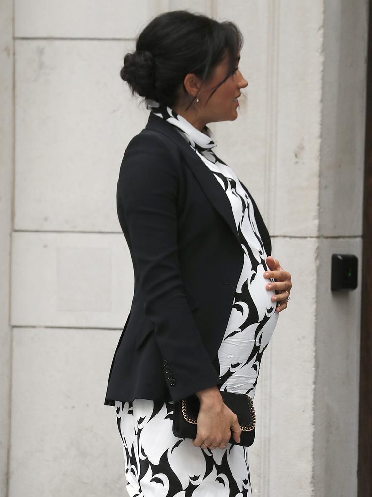 Meghan touches her growing belly. Picture: Frank Augstein/AP