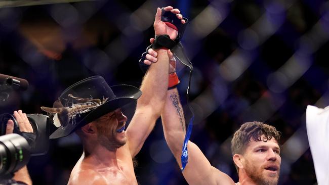 Jim Miller (R) congratulates Donald ‘Cowboy’ Cerrone, as he calls time on his UFC career after going down at UFC 276. Picture: Getty Images, AFP.