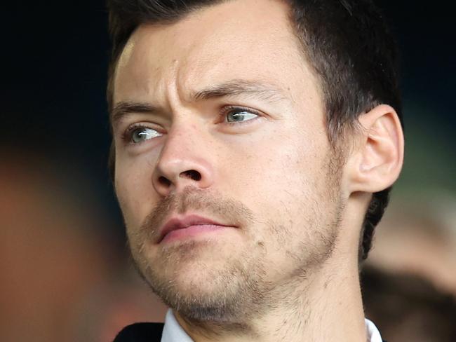 LUTON, ENGLAND - FEBRUARY 18: Harry Styles, English Singer, looks on prior to the Premier League match between Luton Town and Manchester United at Kenilworth Road on February 18, 2024 in Luton, England. (Photo by Catherine Ivill/Getty Images)