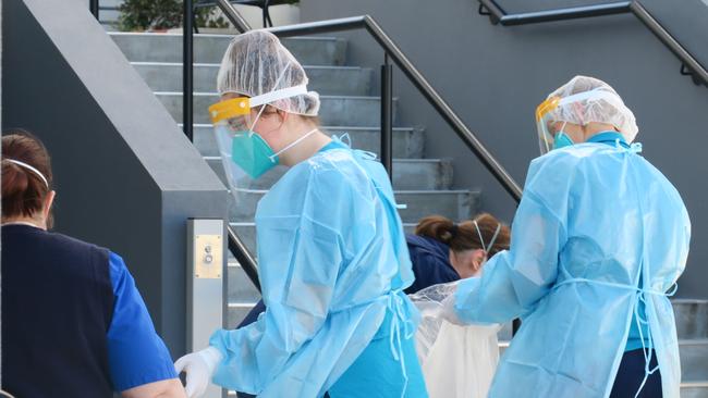 NSW Health workers conducting Covid tests at a unit block at Sturt Rd, Cardiff. Picture: Emily Burley.