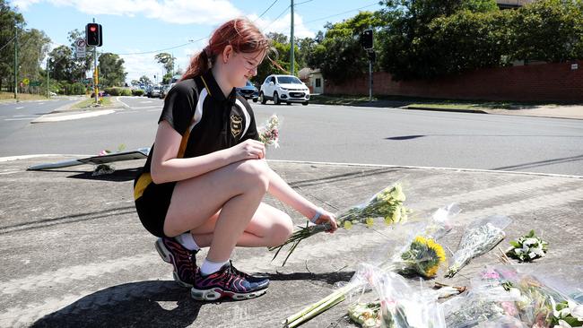 Friend Alyssa Dransfield 12, leaving flowers at the scene. Picture: Tim Hunter