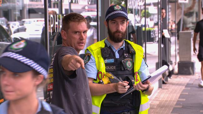 A witness gives details to a police officer in Double Bay. Picture: OnScene Bondi