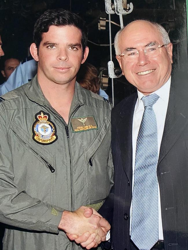 Steven Cook shaking hands with then Prime Minister John Howard.