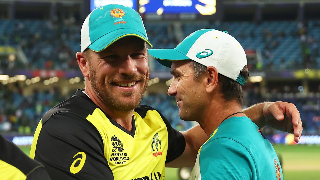 Aaron Finch of Australia and Justin Langer, Head Coach of Australia celebrate following the ICC Men's T20 World Cup semi-final match between Pakistan and Australia at Dubai International Stadium on November 11, 2021 in Dubai, United Arab Emirates. (Photo by Michael Steele-ICC/ICC via Getty Images)