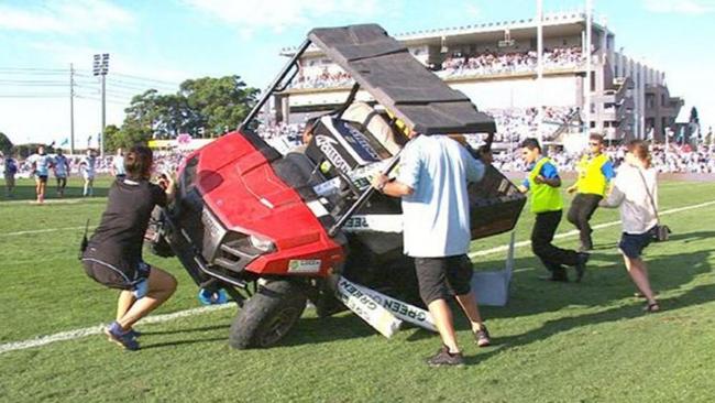 A golf buggy is lifted up after running over the three-year-old son of Cronulla Sharks forward Chris Heighington.