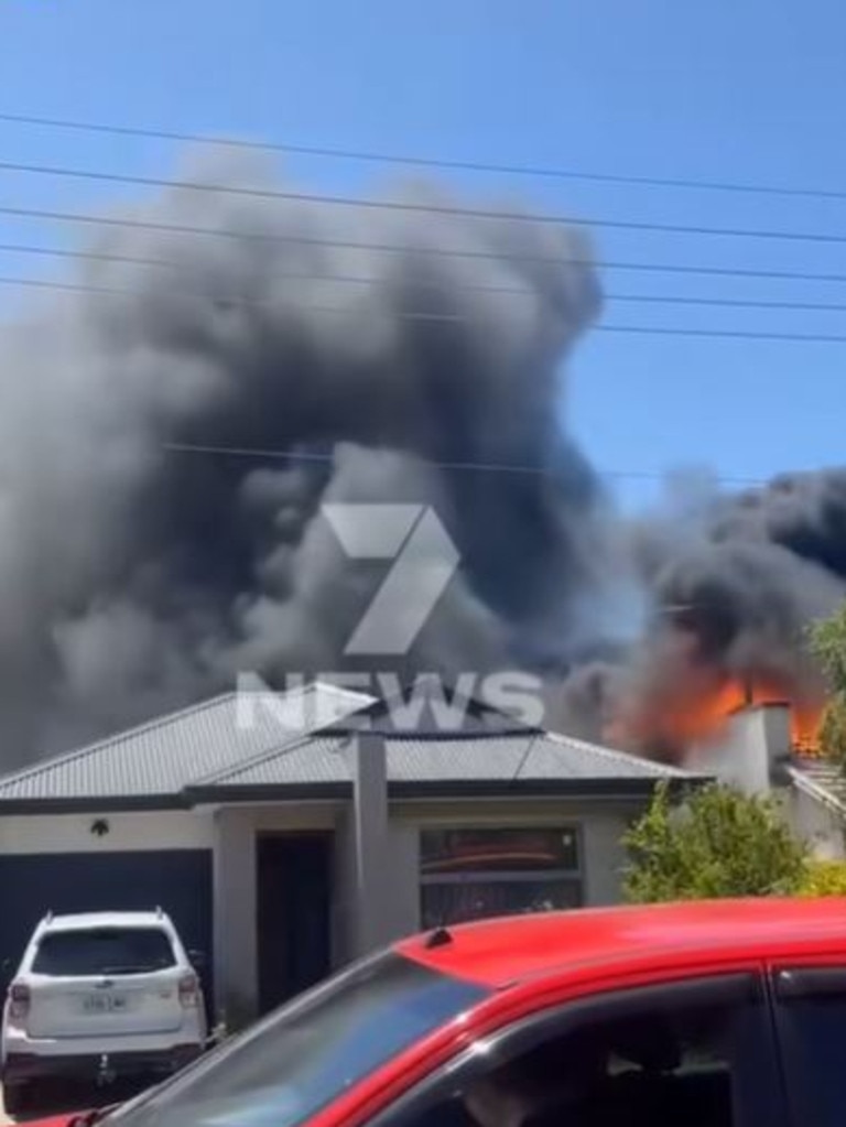 The tradies managed to lift the woman over the fence. Picture: 7NEWS